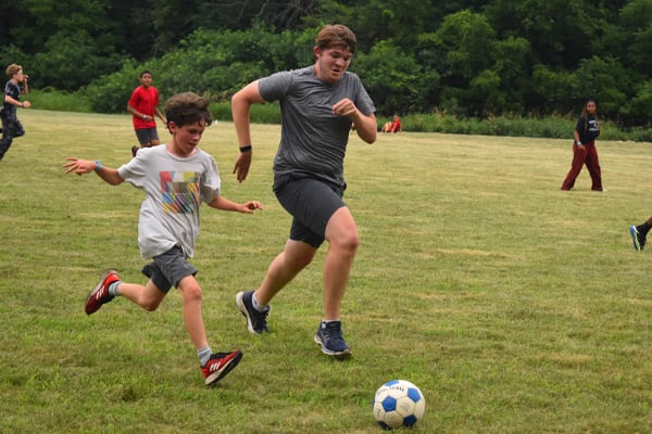Campers and counselors playing soccer at Camp Kupugani in Illinois.